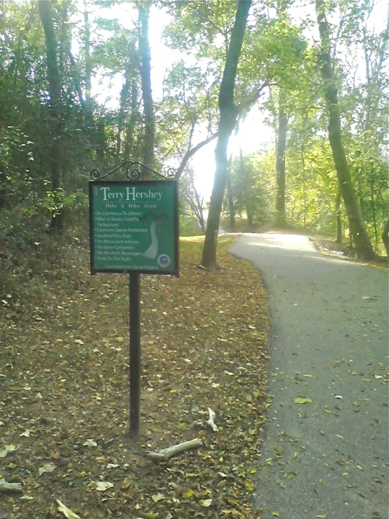 an information board on a pathway in the woods