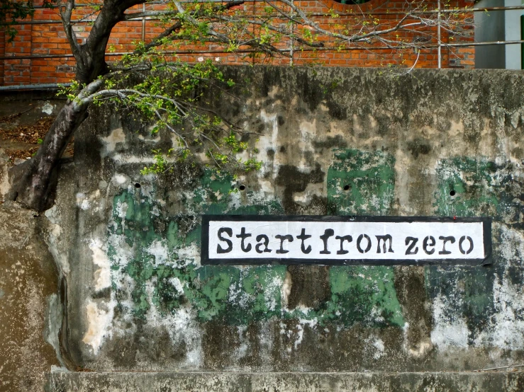 the street sign is displayed against an old wall