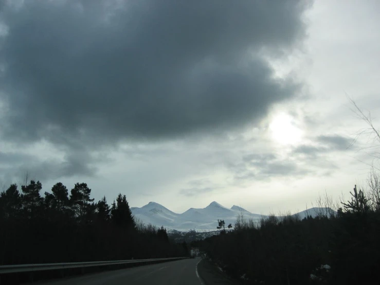 the dark sky is behind the mountain range