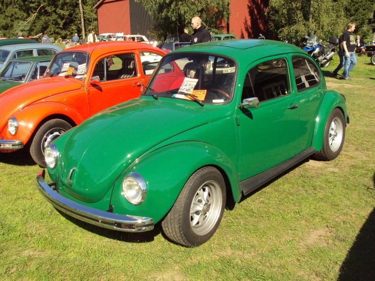 many volkswagen vehicles in different colors are parked