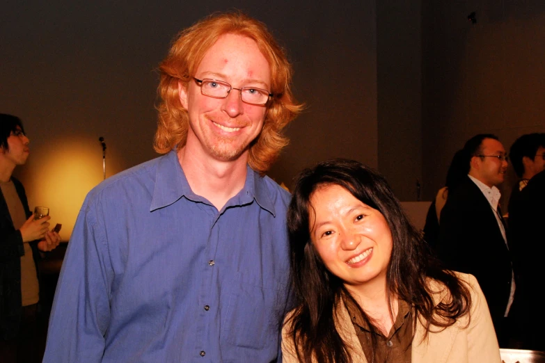 man and woman posing for po at an event