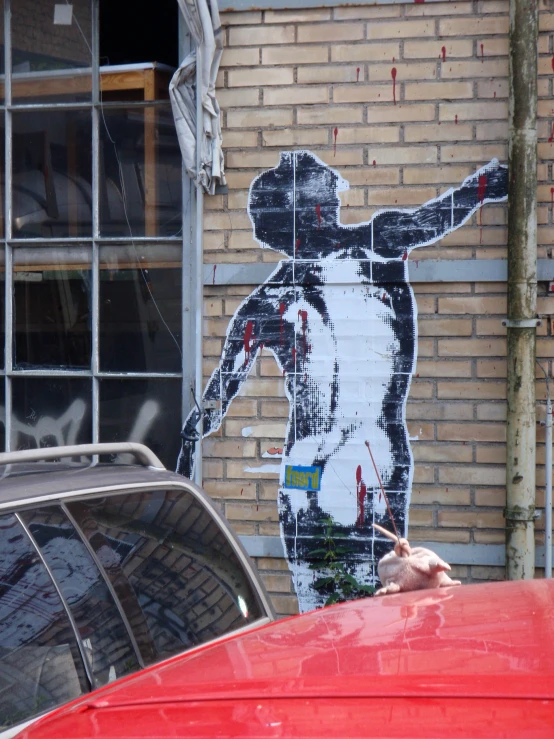 large bankship painting on a brick wall of a man in baseball uniform pointing