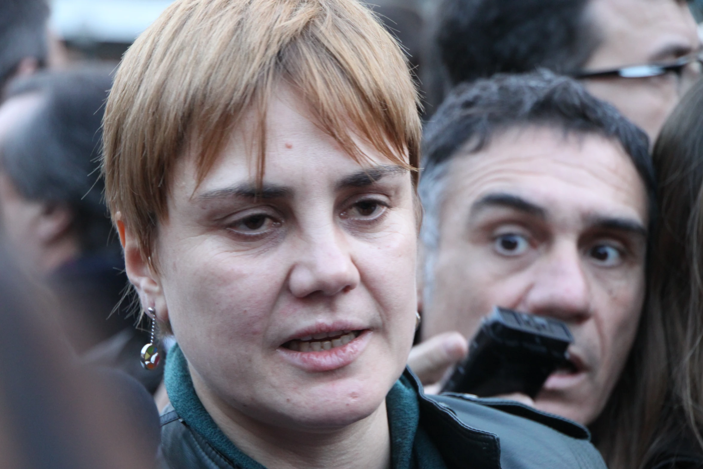 woman talking on phone in crowd of people