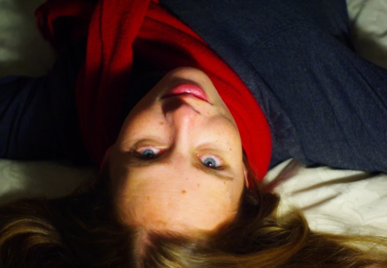 woman with blue eyes laying on her stomach