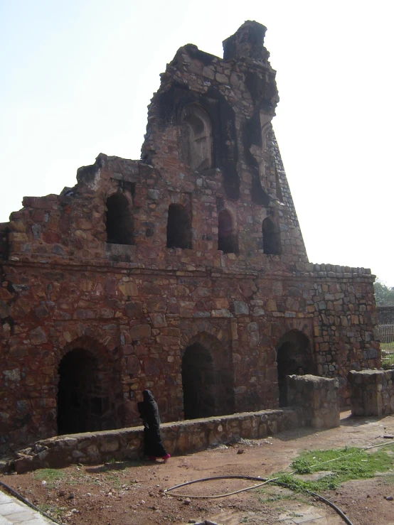 old, abandoned buildings are surrounded by dirt and grass