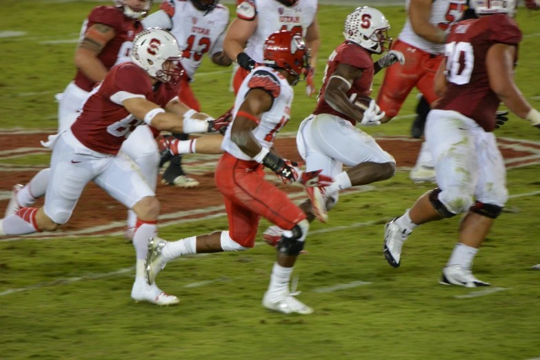 the running football player is in position to run the ball