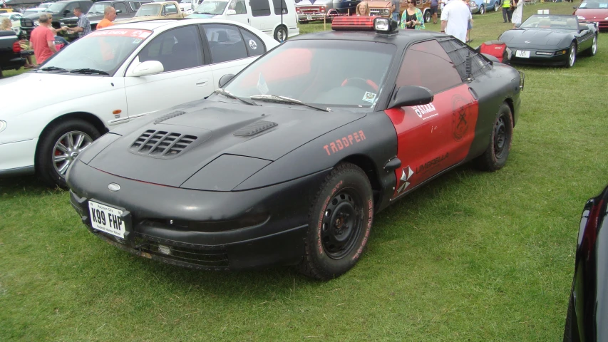 a sports car sits parked in the grass