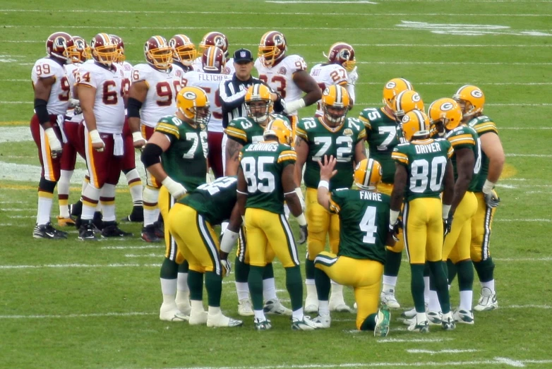 a group of football players standing next to each other