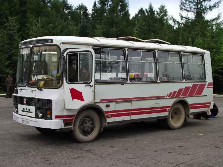 a bus sits in the parking lot while another is sitting nearby