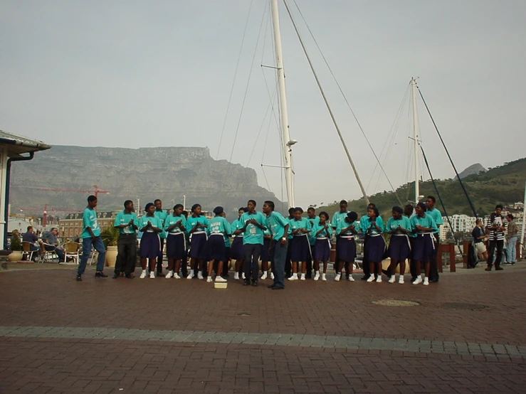 a group po of people on the dock near boats