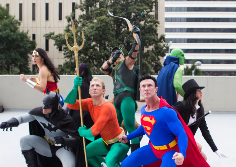 a group of people dressed in costumes standing on snow