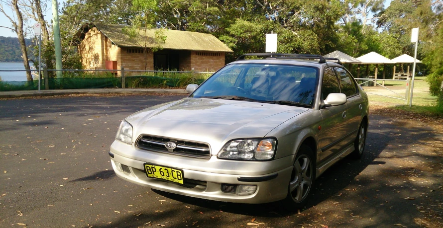 silver vehicle with small camper mounted on top