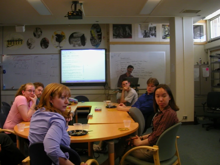 a group of people are sitting at the table