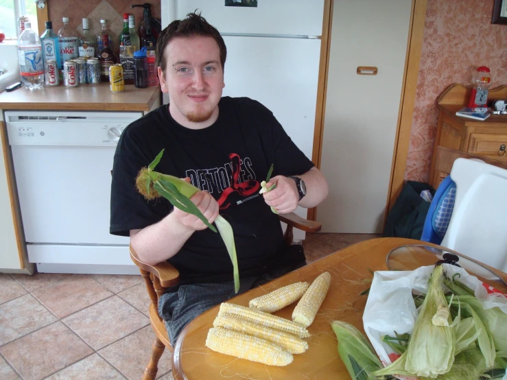 a man sitting at a table  corn