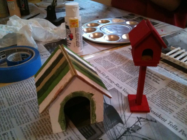 an image of a dog house that is made from newspaper