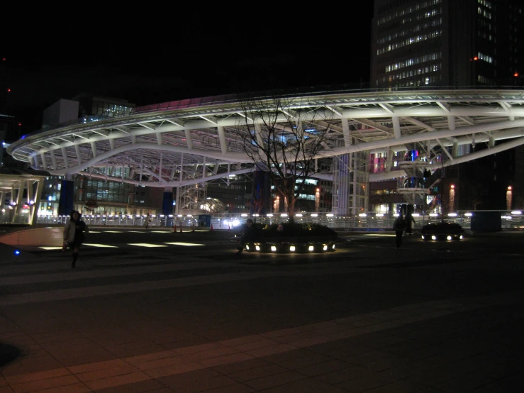 a large bridge spanning over a road surrounded by tall buildings