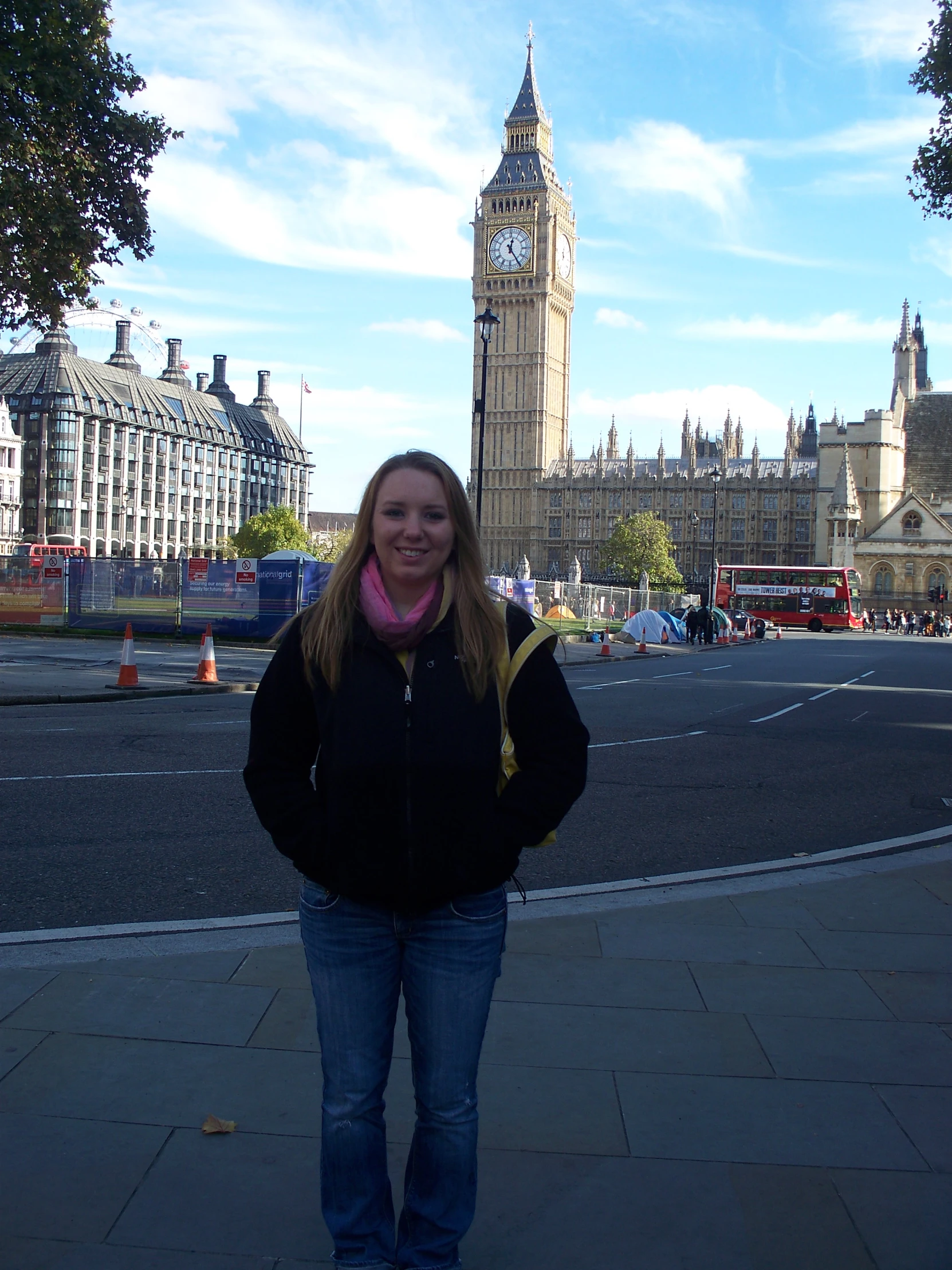 a woman standing on a sidewalk next to a building