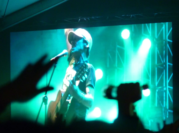 a man that is standing in front of a microphone