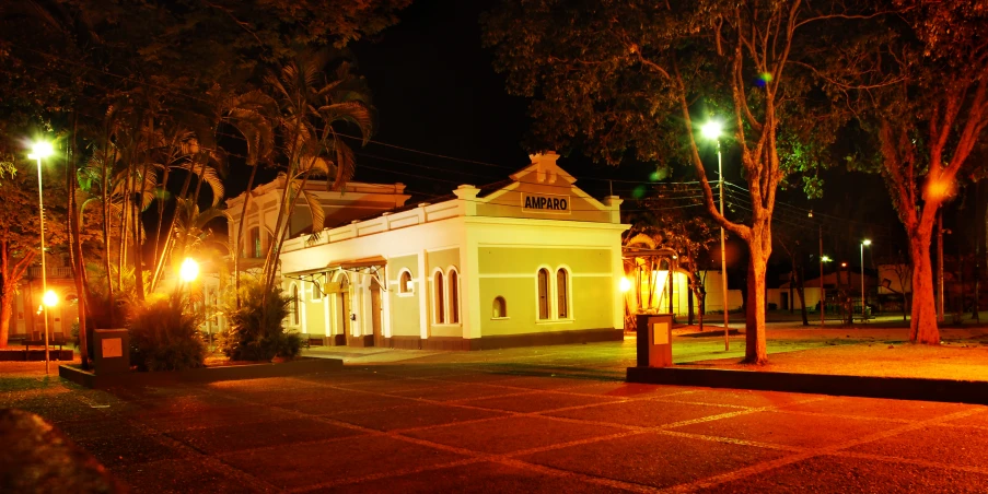 an old building lit up in the night with lights