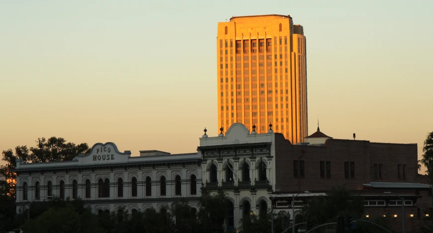 the building has many windows in it as the sun is rising