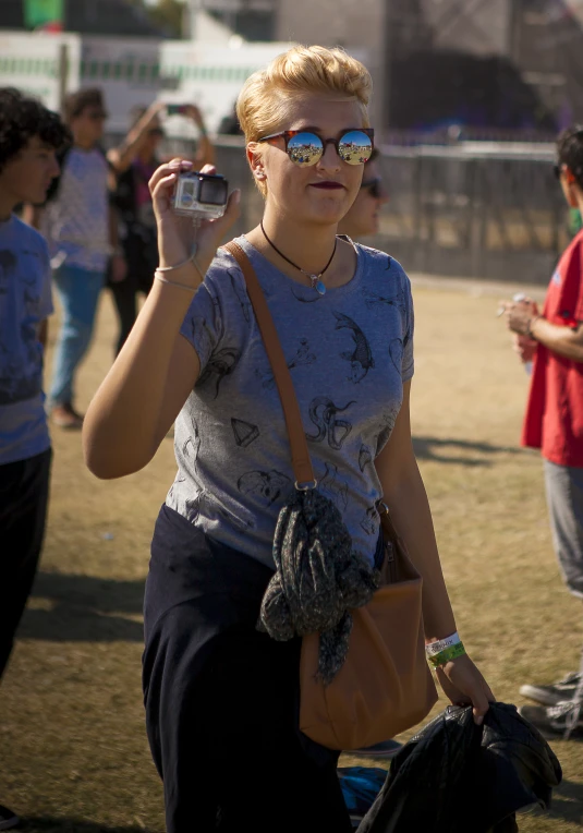 a woman in a crowd using a cell phone