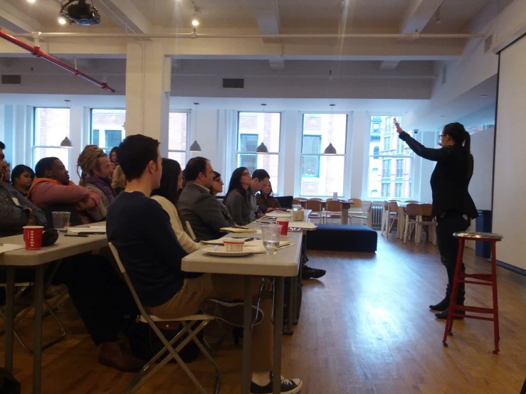 a woman giving a lecture at a conference