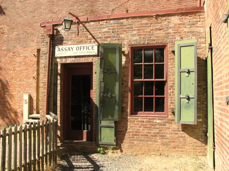 the brick building has two doors and an entrance