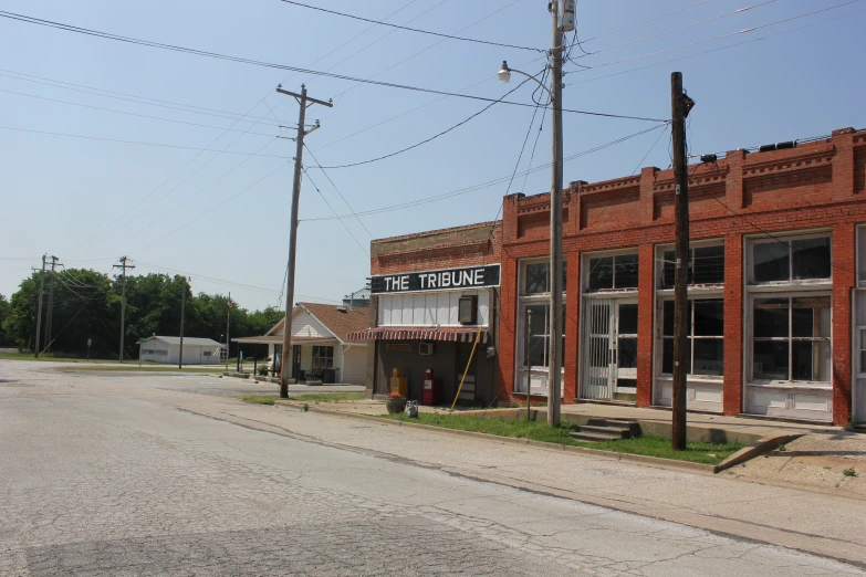 an old red brick store with sign out front