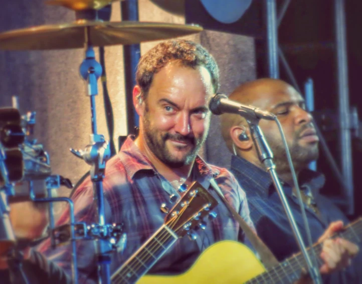 a close up of a person playing a guitar