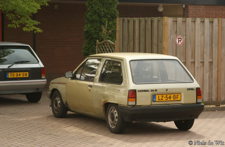 a parked car sitting in front of a brick building