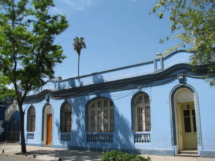a blue building sitting on a side walk