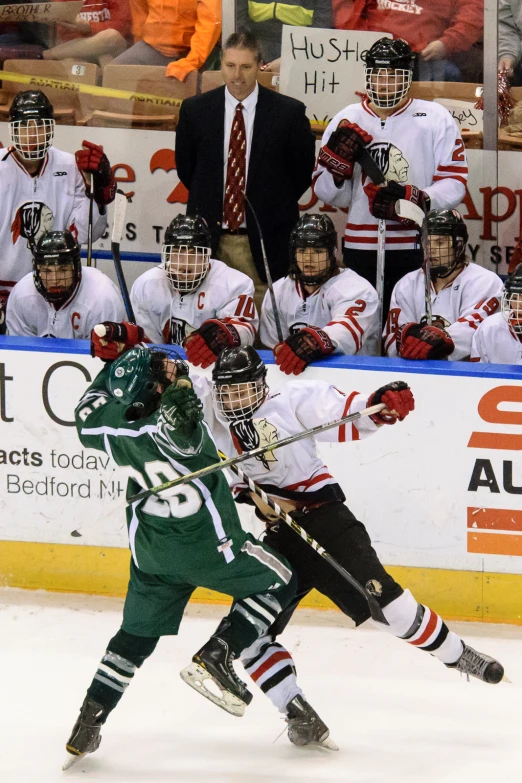 an ice hockey player is skating and some people are watching