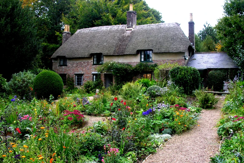 a pretty home with lots of flowers and plants