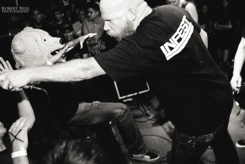 man playing with a cell phone in black and white