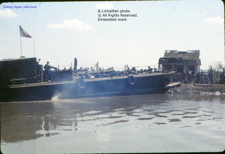 a large barge docked with several people on it