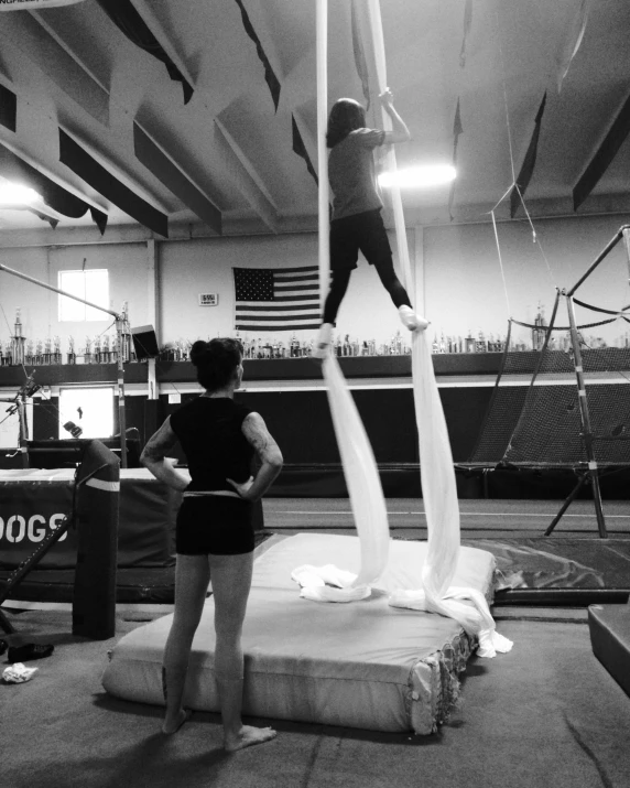 woman on parallel beam in gym area of building