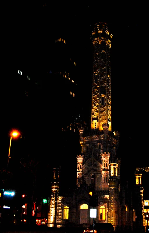 a large tall brick tower lit up at night