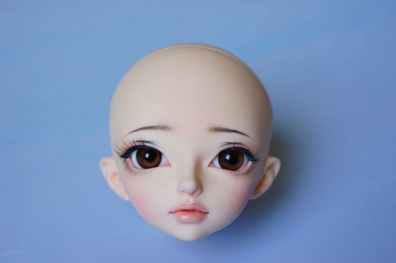 a doll is looking at the camera with wide eyes
