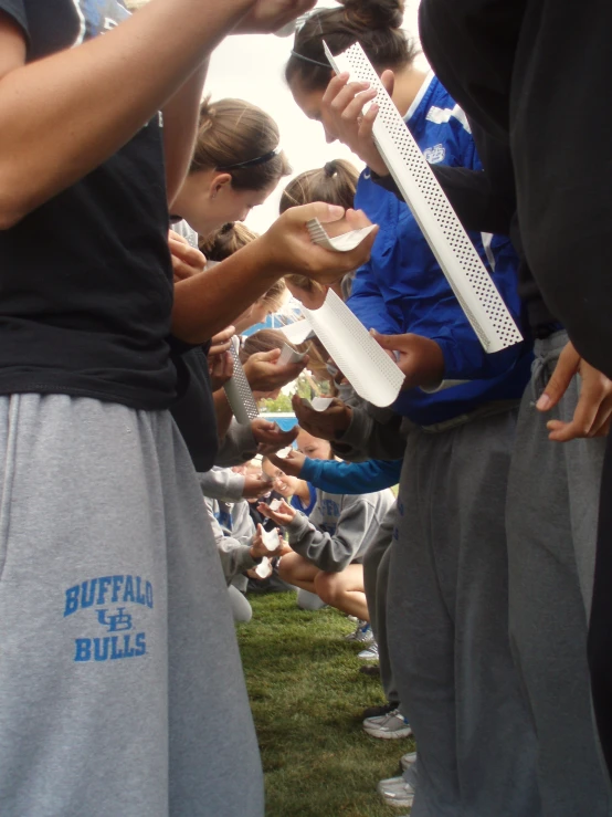 a group of people are holding large items in their hands