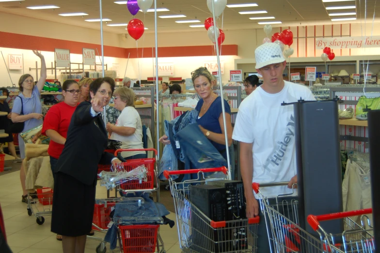 people stand in the grocery aisle in an empty department store