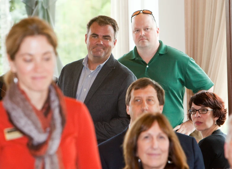 several people are standing together in an office