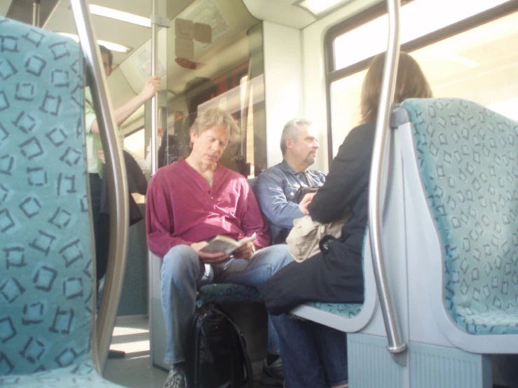 people sitting in the front seat of a train