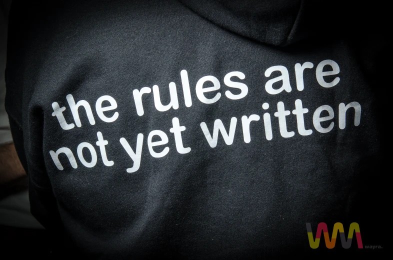 a person with a hoodie that says the rules are not yet written