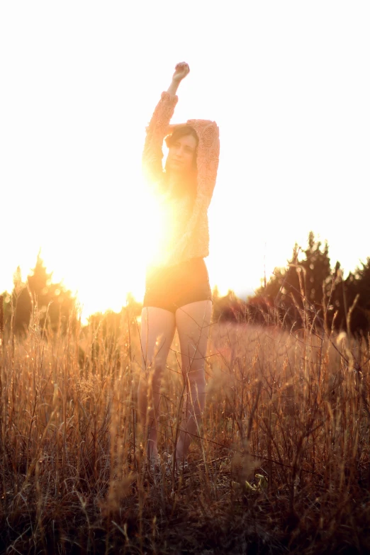 a lady with an umbrella walks in a field