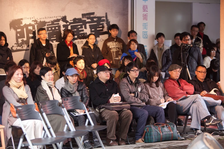 a group of people that are sitting on chairs