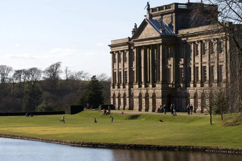 a large building surrounded by grass and water