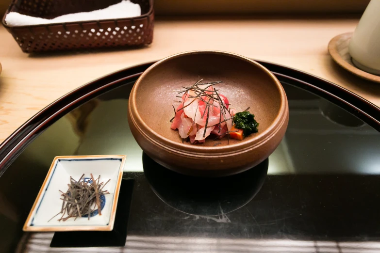 a wooden bowl on top of a glass counter