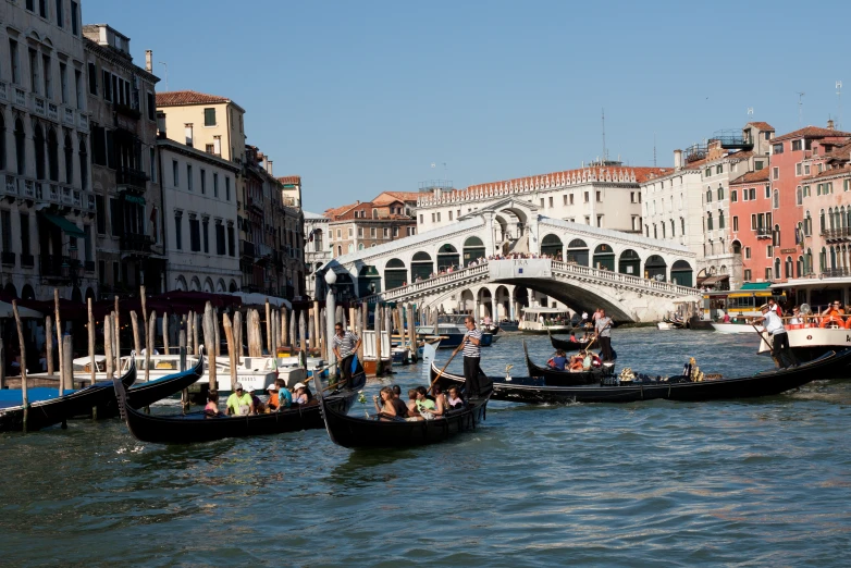 some gondolas in the water and people going down them