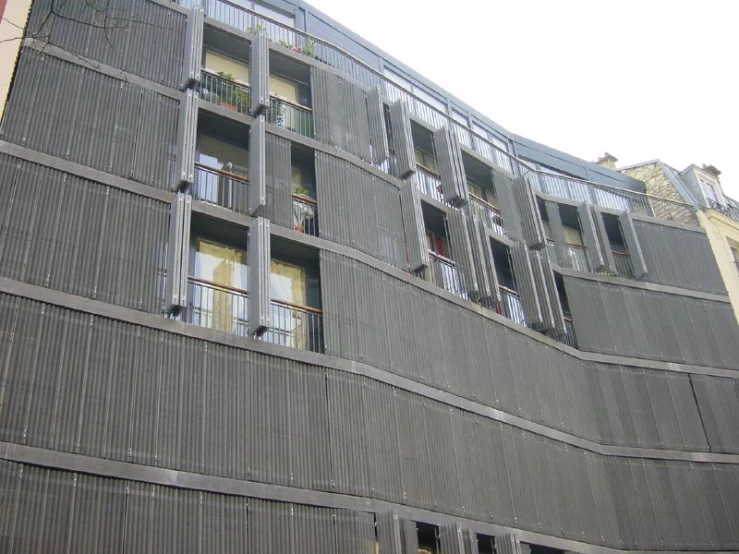 a tall building with many windows and balconies