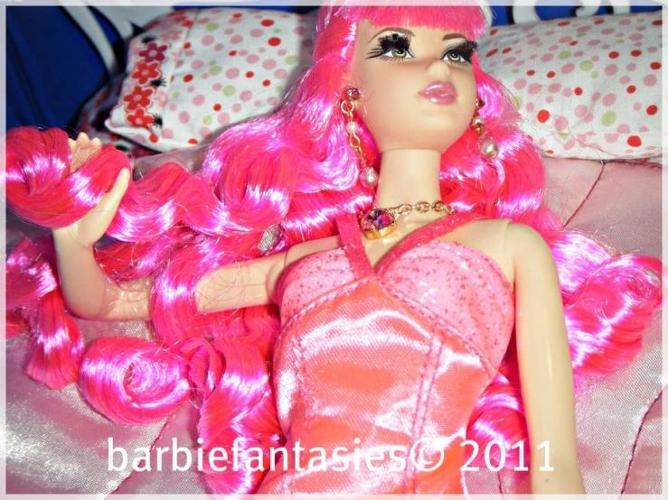 there is a barbie doll laying down on the bed